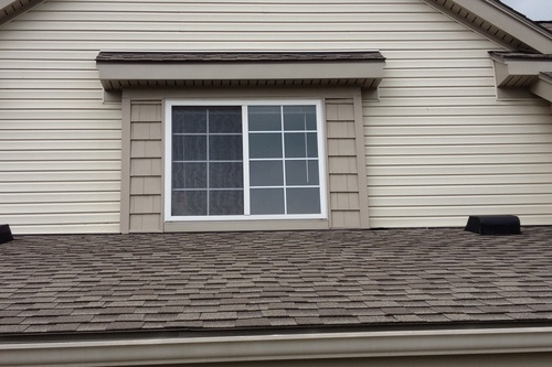 Bump out window on a home with beige siding. Home Contractors Ann Arbor