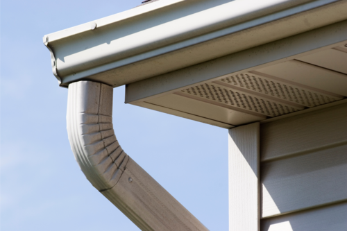 Roofing company in ann arbor shows a photo of a clean gutter on home.