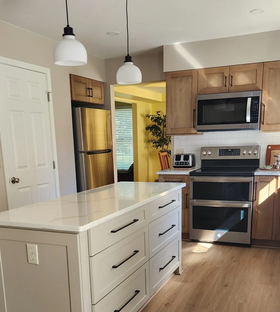 Kitchen remodel with white island, wood cabinets, and stainless appliances in Ann Arbor.
